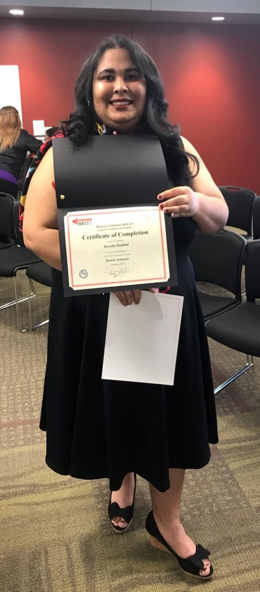 Image of smiling Latina woman holding certificate